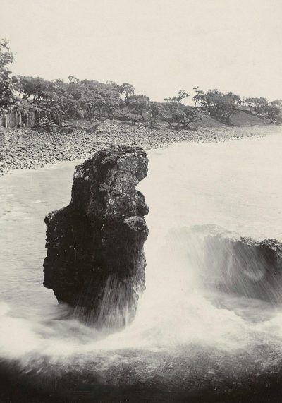 A black and white photograph of the Sylinder rock in horizontally position standing on its side at Isla de Tenerife, Spain, with water cascading off it into rough waves. The background shows trees and rocks along an open river valley, taken by photographer [Eadweard Muybridge](https://goo.gl/search?artist%20Eadweard%20Muybridge) from his masterpiece 'The Boticelli extends to one" series.