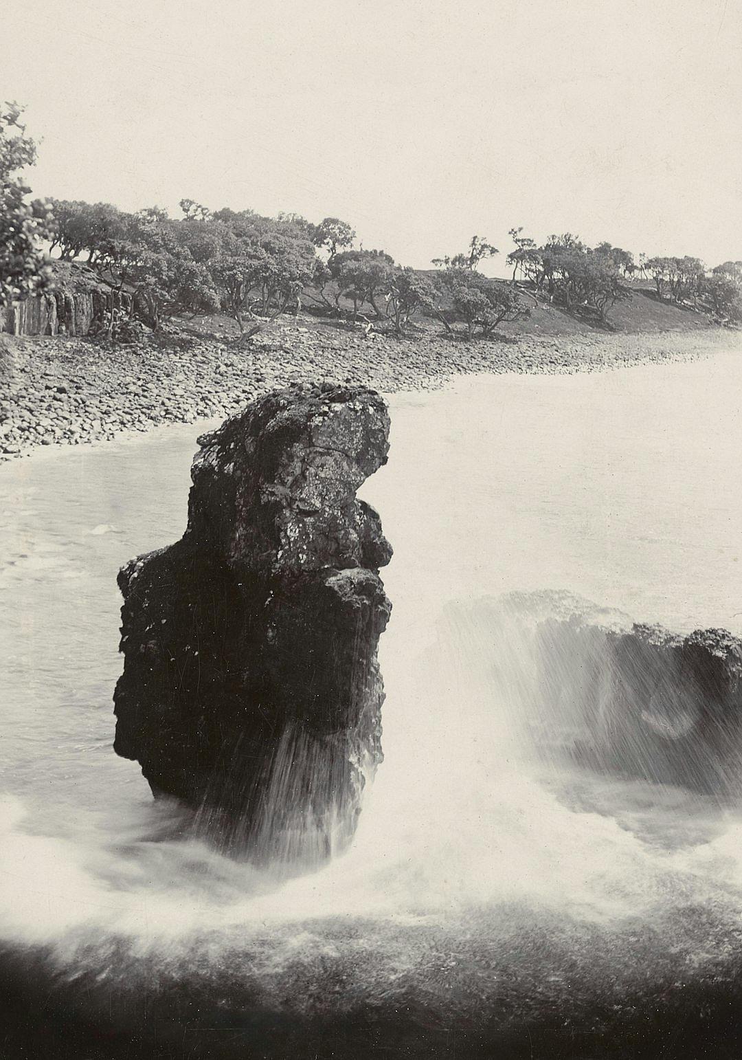 A black and white photograph of the Sylinder rock in horizontally position standing on its side at Isla de Tenerife, Spain, with water cascading off it into rough waves. The background shows trees and rocks along an open river valley, taken by photographer [Eadweard Muybridge](https://goo.gl/search?artist%20Eadweard%20Muybridge) from his masterpiece ‘The Boticelli extends to one” series.